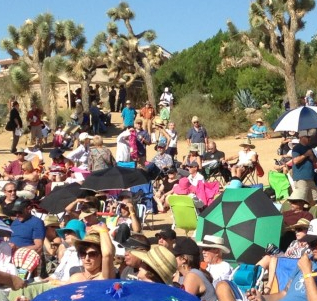Conference attendees take refuge under umbrellas